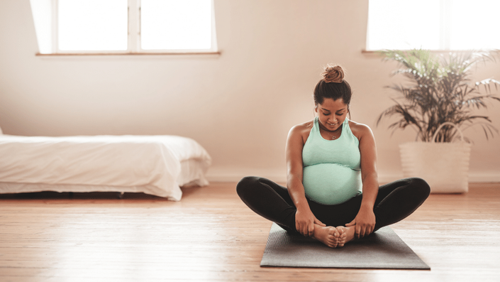 Wall Mural Pregnant woman doing yoga exercise 