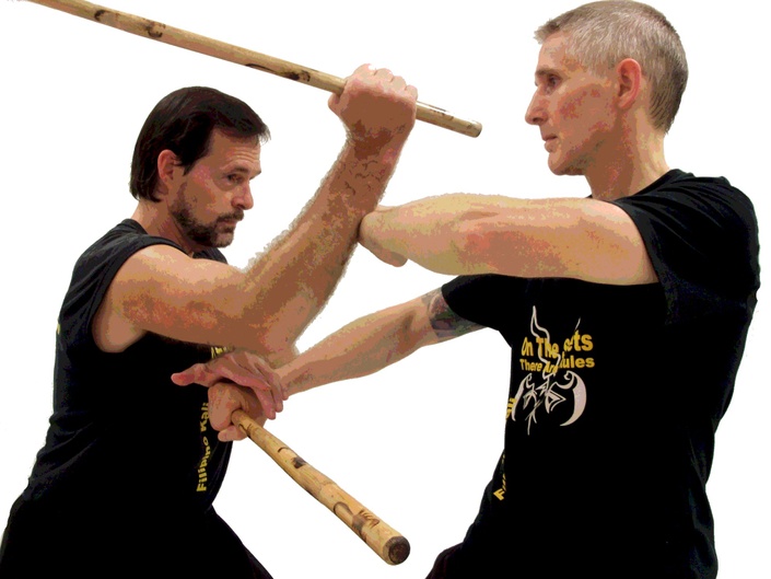 two men sparring with Filipino stick fighting martial arts Stock Photo